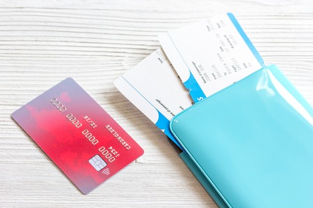passport, credit card, tickets on wooden background close up