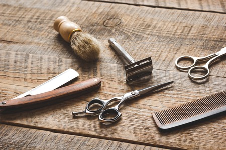Tools for cutting beard barbershop on wooden background.