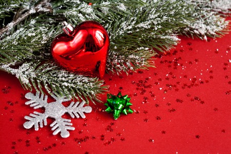 Christmas toys and spruce branches on red background top view.の写真素材