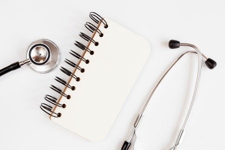 Entry to the doctor blank open notebook with stethoscope top viewの写真素材
