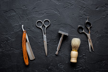 Tools for cutting beard barbershop top view on dark background