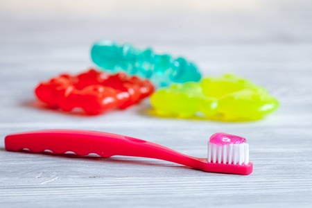 children's toothbrush oral care on wooden background.の写真素材