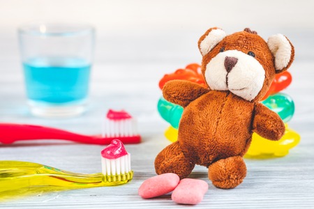 children's toothbrush oral care on wooden background.の写真素材