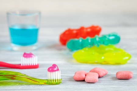 children's toothbrush oral care on wooden background.の写真素材