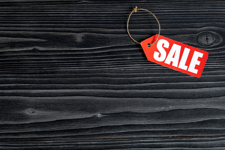 concept of sale on dark wooden background top view.の写真素材