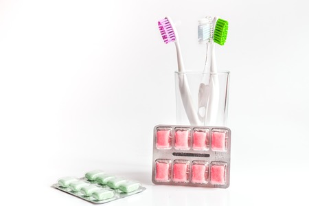 toothbrushes in glass on white background tools for oral care.の写真素材
