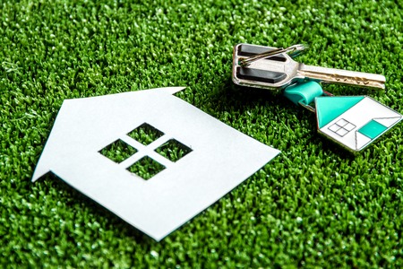 concept of buying house on green background close upの写真素材