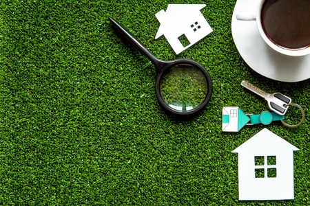 concept of buying house on green background top view.の写真素材