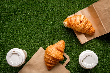 take out in paper bag on green background top view.の写真素材