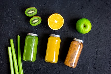 freshly squeezed juices for detox on dark background top view.の写真素材