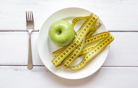 concept diet and weight loss on wooden background top view.の写真素材
