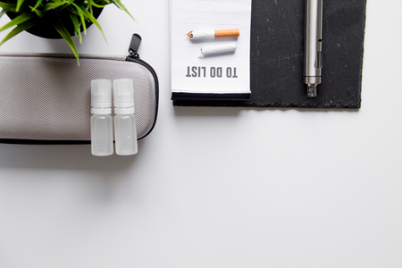 concept of electronic cigarette on white background top view - harm of smoking