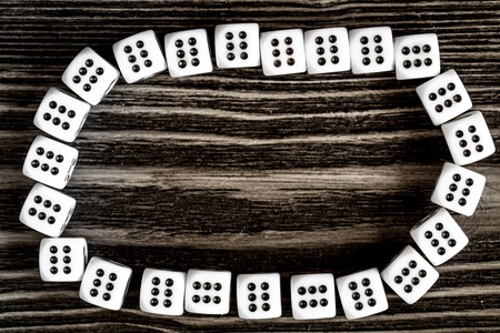 risk concept - playing dice at dark wooden background top viewの写真素材