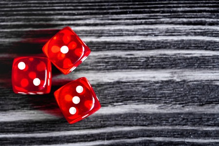 risk concept - playing dice at dark wooden background top viewの写真素材