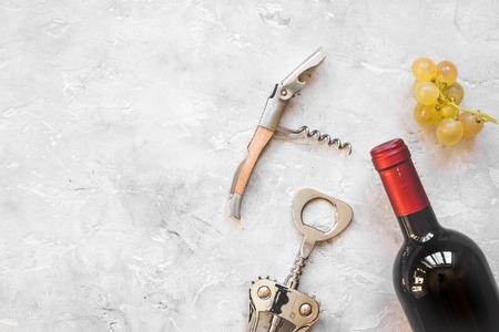 glass wine bottle and corkscrew on concrete background top view.の写真素材