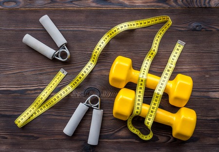 concept preparing to fitness sports equipment top view on wooden backgroundの写真素材