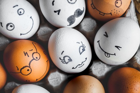 concept social networks communication and emotions - eggs smile in boxの写真素材