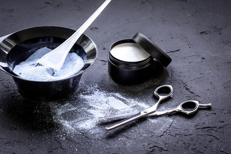 hair dye with brush on dark background close upの写真素材