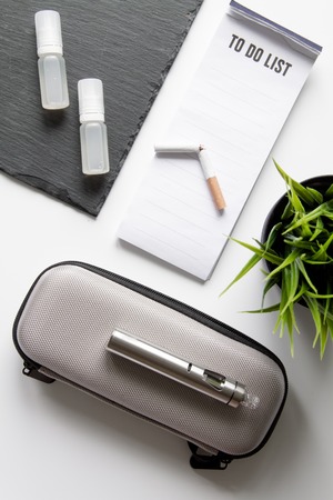 concept of dangers of smoking and electronic cigarette on white background top viewの写真素材