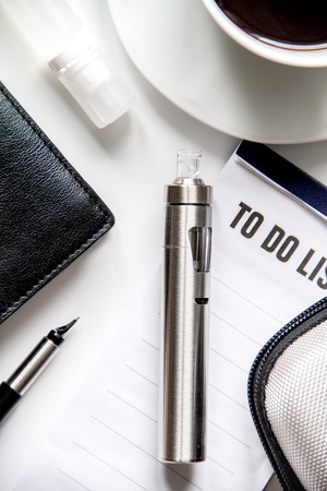 smartphone, electronic cigarette and men's accessories top view.