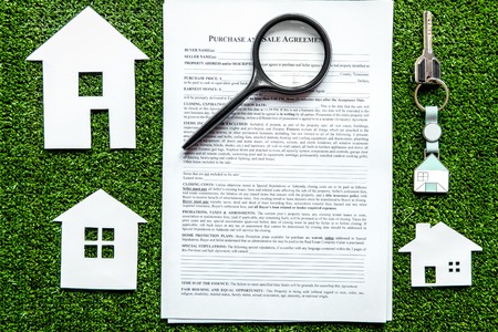 concept of buying house on green background top view.