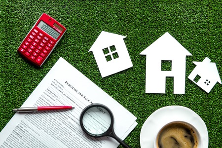 concept of buying house on green background top view.の写真素材