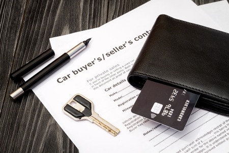 concept of buying car on dark wooden background close upの写真素材