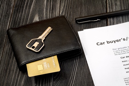 concept of buying car on dark wooden background close upの写真素材