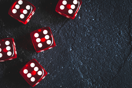 risk concept - playing dice at dark background top view