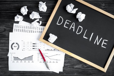 deadline concept on dark wooden background top view.の写真素材