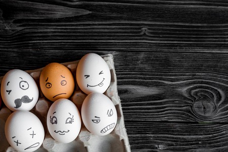 concept social networks communication and emotions - eggs on dark wooden backgroundの写真素材