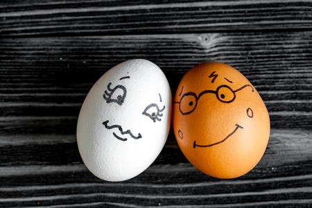 concept human relationships and emotions eggs - romance on dark wooden backgroundの写真素材