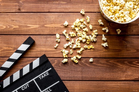 watching movie with popcorn on wooden background top view.の写真素材