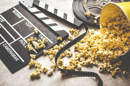 watching movie with popcorn on gray background close up.