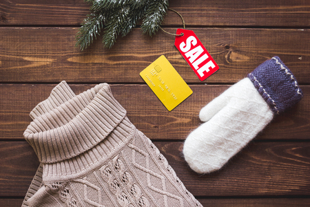 Christmas clothing sale on wooden background top view.の写真素材