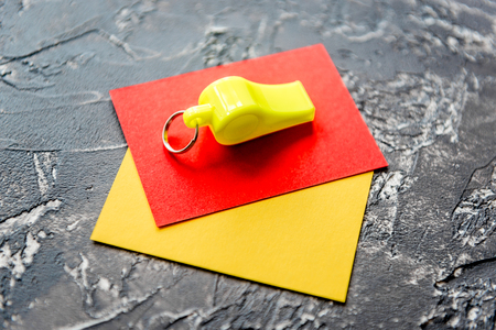 red and yellow cards on dark background close up.の写真素材