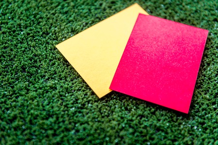 red and yellow cards on green background close up mock upの写真素材