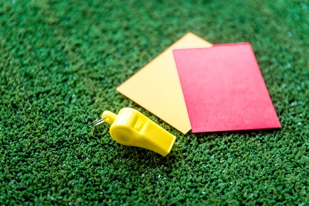 red and yellow cards on green background close up mock upの写真素材