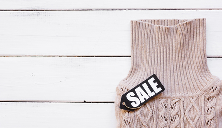 concept holiday sales of clothes and textiles top view on wooden backgroundの写真素材
