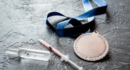 Concept of doping in sport - deprivation medals close up on dark backgroundの写真素材