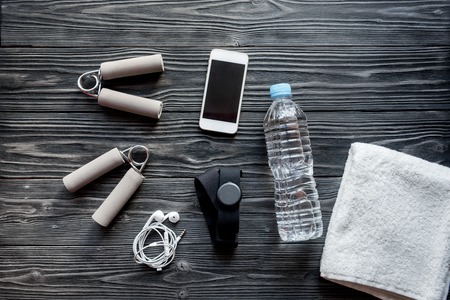 concept preparing to fitness sports equipment top view on wooden backgroundの写真素材