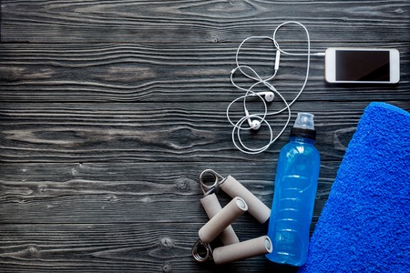 concept preparing to fitness sports equipment top view on wooden background