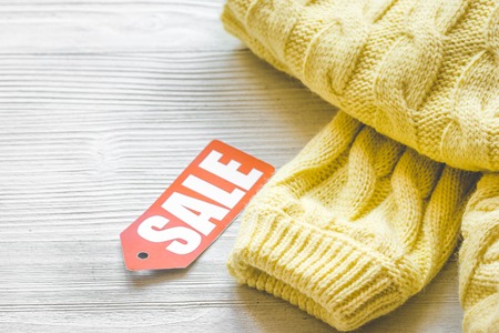 concept holiday sales of clothes and textiles on wooden background