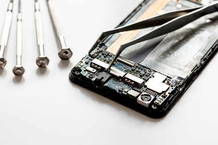 concept repair smartphone gadgets on white background close upの写真素材