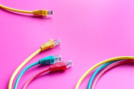 concept network internet cable on pink background close up.