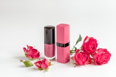 berry color decorative cosmetics with roses on white background close upの写真素材
