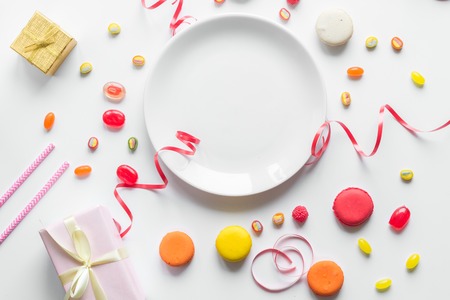 Gift box with colorful party items on white background top view mock upの写真素材