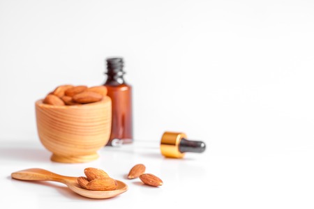 cosmetic almond oil in glass bottle on white background.の写真素材