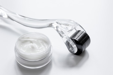 concept beautician desktop with mezoroller - mesotherapy on white background.の写真素材