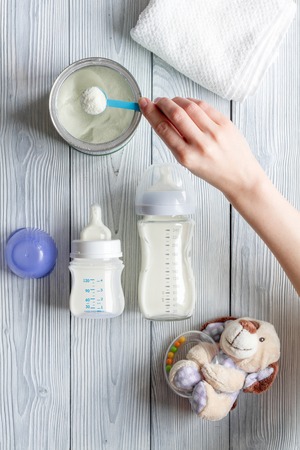 preparation of mixture baby feeding on wooden background top viewの写真素材